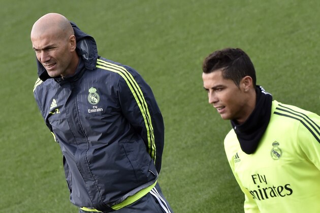 Real Madrid's new French coach Zinedine Zidane (L) and Real Madrid's Portuguese forward Cristiano Ronaldo take part in a training session at the Valdebebas training ground in Madrid on January 8, 2016.   AFP PHOTO / GERARD JULIEN / AFP / GERARD JULIEN        (Photo credit should read GERARD JULIEN/AFP/Getty Images)
