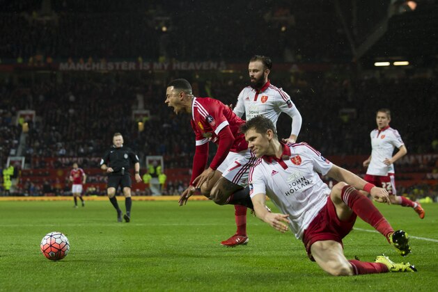 Manchester United's Memphis Depay, centre, is brought down for a penalty by Sheffield United's Dean Hammond, bottom right, during the English FA Cup third round soccer match between Manchester United and Sheffield United at Old Trafford Stadium, Manchester, England, Saturday Jan. 9, 2016. (AP Photo/Jon Super)
