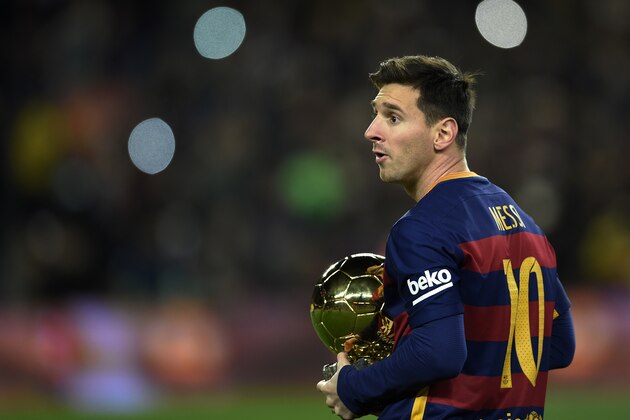 Barcelona's Argentinian forward Lionel Messi walks away after posing with his fifth Ballon d'Or trophy before the Spanish league football match FC Barcelona vs Athletic Club Bilbao at the Camp Nou stadium in Barcelona on January 17, 2016.    / AFP / LLUIS GENE        (Photo credit should read LLUIS GENE/AFP/Getty Images)