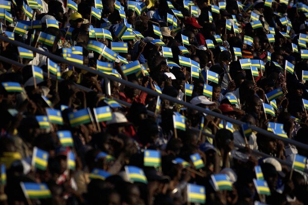 Kigali, RWANDA:  Rwandan fans wave flags 10 December 2005 during the CECAFA cup final against Ethiopia at Kigali Stadium, Rwanda. AFP PHOTO/JOSE CENDON  (Photo credit should read JOSE CENDON/AFP/Getty Images)