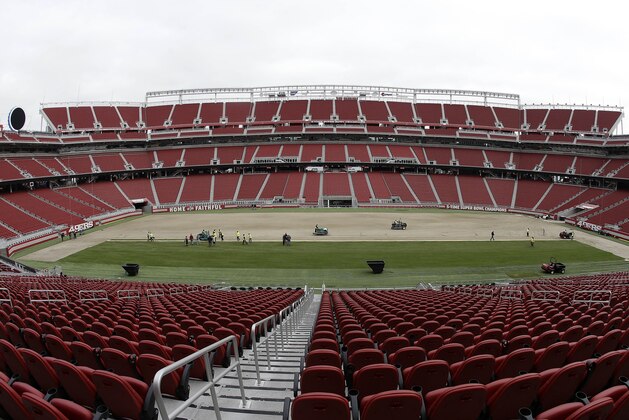 In this photo taken with a fisheye lens, workers install sod on the field at Levi's Stadium in preparation for the NFL's Super Bowl 50 in Santa Clara, Calif., Monday, Jan. 11, 2016. Less than four weeks out from the Super Bowl, the field is nearly ready to be played on thanks to long days at Levi’s Stadium by the crew working to install fresh sod and make every necessary tweak in regards to weather and other potential issues. (AP Photo/Jeff Chiu)