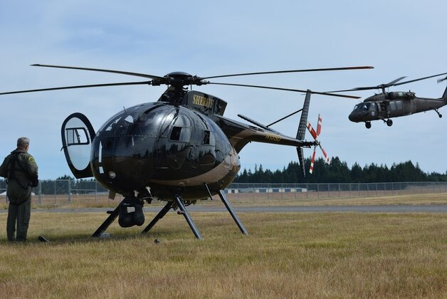 In this July 15, 2015, photo provided by the Washington State Army National Guard, a Washington National Guard UH- 60 Black Hawk helicopter, right, lands next to a Snohomish County Sheriff's Department helicopter during exercise Evergreen Tremor, to prepare for a Cascadia Subduction Zone earthquake. For the past few years emergency officials in the Pacific Northwest have been drafting detailed contingency plans for the day a mega-quake and tsunami hit the region.  (Washington State Army National Guard via AP)