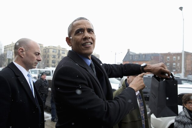 President Barack Obama points to his watch as he leaves a tour of Shinola, a domestic manufacturer of watches and other goods, Wednesday, Jan. 20, 2016, in Detroit. While in Detroit the president is scheduled to visit the 2016 North American International Auto Show and speak of the progress made by the city, its people and neighborhoods, and the American auto industry. (AP Photo/Carolyn Kaster)
