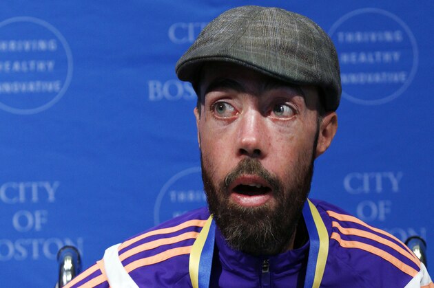 Maickel Melamed, of Venezuela, the last participant to finish this year's Boston Marathon, speaks after receiving a medal from Boston Mayor Marty Walsh during a ceremony, Tuesday, April 21, 2015, in Boston. Melamed, 39, has a form of muscular dystrophy which severely impairs his mobility. He crossed the finish line about 20 hours after he started. (AP Photo/Bill Sikes)