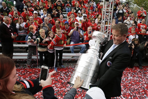 Mike Bolt carries the Stanley Cup on the red carpet before an NHL hockey game between the New York Rangers and the Chicago Blackhawks  Wednesday, Oct. 7, 2015, in Chicago. (AP Photo/Nam Y. Huh)