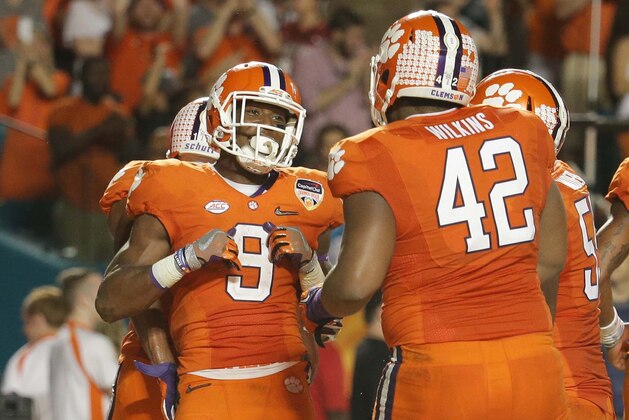 Clemson running back Wayne Gallman (9) celebrates his touchdown with defensive lineman Christian Wilkins (42) during the second half of the Orange Bowl NCAA college football semifinal playoff game against Oklahoma, Thursday, Dec. 31, 2015, in Miami Gardens, Fla.  (AP Photo/Lynne Sladky)
