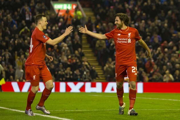 Liverpool's Joe Allen, right, celebrates with teammate Brad Smith after scoring against Exeter during the English FA Cup third-round replay soccer match between Liverpool and Exeter at Anfield Stadium, Liverpool, England, Wednesday Jan. 20, 2016. (AP Photo/Jon Super)