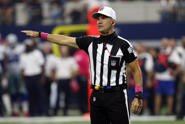 Referee Clete Blakeman (34) makes a call as he wears a ball cap with a pink accented attire in observance of Breast Cancer Awareness during an NFL football game between the New England Patriots and Dallas Cowboys, Sunday, Oct. 11, 2015, in Arlington, Texas. (AP Photo/Roger Steinman)