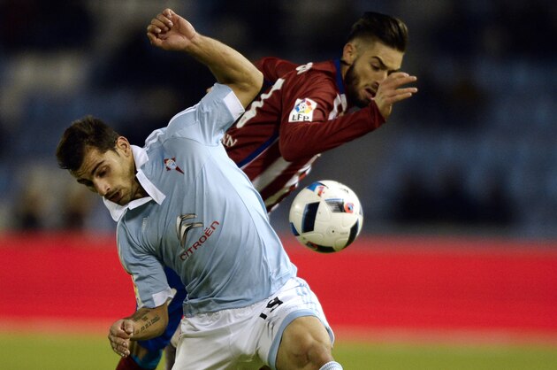 Celta Vigo's defender Jonny Castro (L) vies with Atletico Madrid's Belgian midfielder Yannick Ferreira Carrasco during the Spanish Copa del Rey (King's Cup) football match Celta Vigo vs Club Atletico de Madrid at the Balaidos stadium in Vigo on January 20, 2016.  AFP PHOTO / MIGUEL RIOPA / AFP / MIGUEL RIOPA        (Photo credit should read MIGUEL RIOPA/AFP/Getty Images)