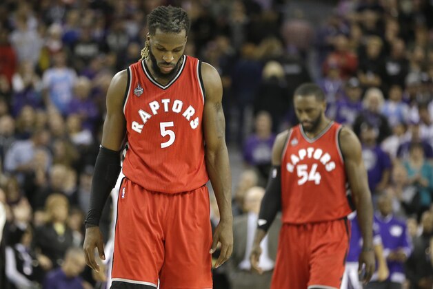 Toronto Raptors' DeMarre Carroll left, and Patrick Patterson, right, walk down court in the closing moments of the Raptors 107-101 loss to the Sacramento Kings in an NBA basketball game in Sacramento, Calif., Sunday, Nov. 15, 2015.(AP Photo/Rich Pedroncelli)