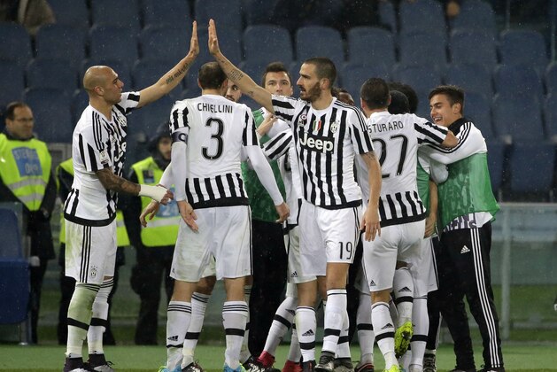 Juventus players celebrate after their teammate  Stephan Lichtsteiner scored during an Italian Cup soccer match between Lazio and Juventus, at Rome's Olympic Stadium, Wednesday, Jan. 20, 2016. (AP Photo/Andrew Medichini)