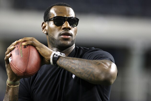 NBA star LeBron James plays catch on the field following an NFL football game between the New York Giants and Dallas Cowboys,  Sunday, Sept. 20, 2009, in Arlington, Texas. (AP Photo/Sharon Ellman)