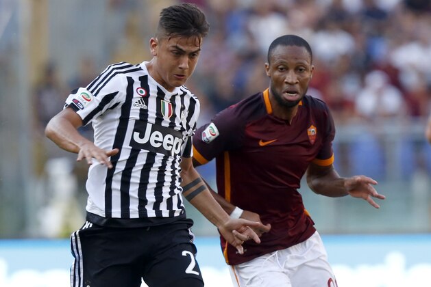 Juventus’ Paulo Dybala, left, is chased by Roma’s Seydou Keita during a Serie A soccer match between Roma and Juventus, at Rome's Olympic stadium, Sunday, Aug. 30, 2015. (AP Photo/Riccardo De Luca)