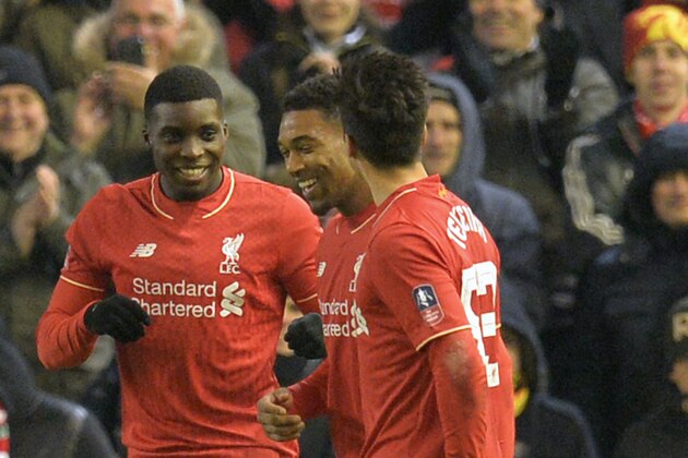 Liverpool's English midfielder Oluwaseyi Ojo (L) celebrates with teammates after scoring their second goal during the English FA Cup third round replay football match between Liverpool and Exeter City at Anfield in Liverpool, north west England on January 20, 2016. AFP PHOTO / PAUL ELLIS

RESTRICTED TO EDITORIAL USE. No use with unauthorized audio, video, data, fixture lists, club/league logos or 'live' services. Online in-match use limited to 75 images, no video emulation. No use in betting, games or single club/league/player publications. / AFP / PAUL ELLIS        (Photo credit should read PAUL ELLIS/AFP/Getty Images)