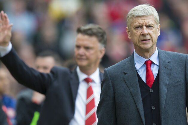 Arsenal's manager Arsene Wenger, right, and Manchester United manager Louis van Gaal take to the touchline before the English Premier League soccer match between Manchester United and Arsenal at Old Trafford Stadium, Manchester, England, Sunday, May 17, 2015. (AP Photo/Jon Super)