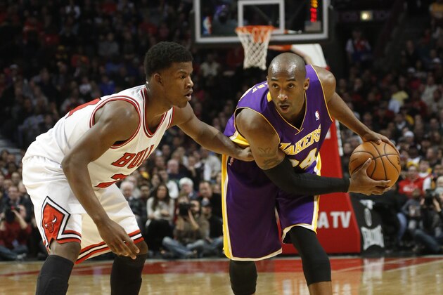 Los Angeles Lakers shooting guard Kobe Bryant, right, is guarded by Chicago Bulls small forward Jimmy Butler during the first  half of an NBA basketball game against the Chicago Bulls Monday, Jan. 21, 2013, in Chicago. The Bulls won 95-83. (AP Photo/Charles Rex Arbogast)