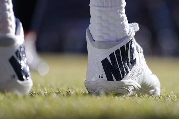 Nike cleats adorn the feet of Denver Broncos quarterback Peyton Manning during the first half in an NFL football game, Sunday, Jan. 3, 2016, in Denver. (AP Photo/Jack Dempsey)