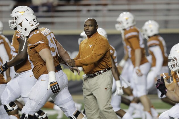 Texas head coach Charlie Strong, center, watches over his team before an NCAA college football game against Kansas, Saturday, Nov. 7, 2015, in Austin, Texas. (AP Photo/Eric Gay)