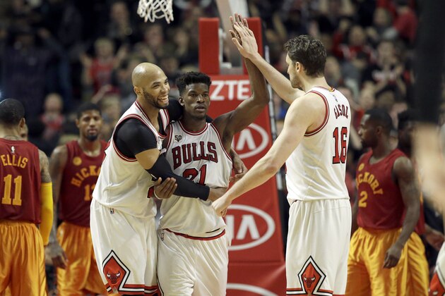 Chicago Bulls  guard/forward Jimmy Butler, center, celebrates with forward Taj Gibson, left, and forward/center Pau Gasol after the Bulls defeated the Indiana Pacers 102-100 in an NBA basketball game Wednesday, Dec. 30, 2015, in Chicago. (AP Photo/Nam Y. Huh)