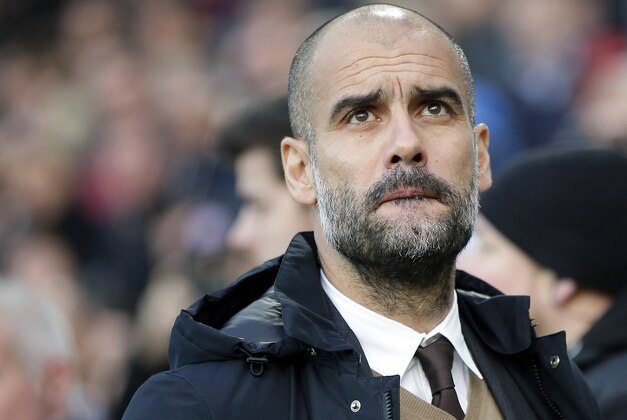 FILE - In this Saturday, Dec. 19, 2015 file photo, Bayern head coach Pep Guardiola arrives for the German Bundesliga soccer match between Hannover 96 and FC Bayern Munich in Hannover, Germany. Pep Guardiola says he wants to coach in the English Premier League when he leaves Bayern Munich at the end of this season, but hasn't yet signed a contract with a club. Guardiola, who opted not to extend his three-year contract at Bayern, said on Tuesday, Jan. 5, 2016