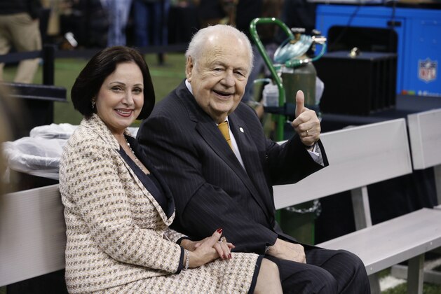 New Orleans Saints owner Tom Benson, sits with his wife Gayle Benson before an NFL football game against the Jacksonville Jaguars in New Orleans, Sunday, Dec. 27, 2015. (AP Photo/Jonathan Bachman)