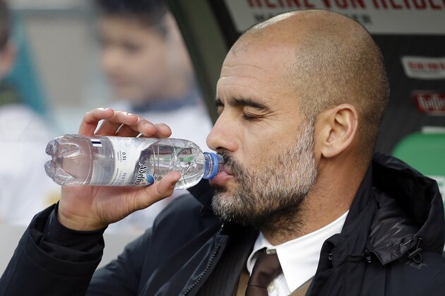 Bayern's  head coach Pep Guardiola drinks as he arrives for the German Bundesliga soccer match between Hannover 96 and FC Bayern Munich in Hannover, Germany, Saturday, Dec. 19, 2015. (AP Photo/Michael Sohn)