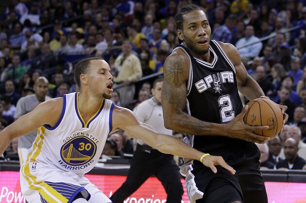 OAKLAND, CA - NOVEMBER 11:  Kawhi Leonard #2 of the San Antonio Spurs drives on Stephen Curry #30 of the Golden State Warriors at ORACLE Arena on November 11, 2014 in Oakland, California. NOTE TO USER: User expressly acknowledges and agrees that, by downloading and or using this photograph, User is consenting to the terms and conditions of the Getty Images License Agreement.  (Photo by Ezra Shaw/Getty Images)