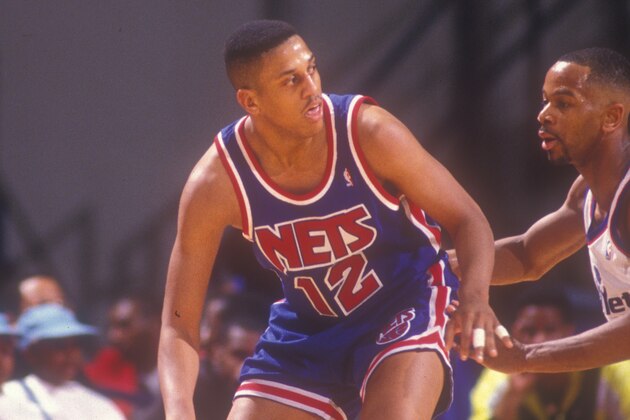 LANDOVER, MD - MARCH 25: Tate George #12 of the New Jersey Nets dribbles the ball during a basketball game against the Washington Bullets at the Capitol Centre on March 25 1991 in Landover , Maryland. The Bullets won 113-106. (Photo by Mitchell Layton/Getty Images)