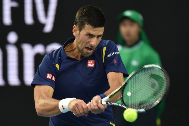 Serbia's Novak Djokovic plays a backhand return during his men's singles match against Italy's Andreas Seppi on day five of the 2016 Australian Open tennis tournament in Melbourne on January 22, 2016. AFP PHOTO / PAUL CROCK-- IMAGE RESTRICTED TO EDITORIAL USE - STRICTLY NO COMMERCIAL USE / AFP / PAUL CROCK        (Photo credit should read PAUL CROCK/AFP/Getty Images)