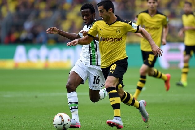 Dortmund's Armenian midfielder Henrikh Mkhitaryan and Moenchengladbach's Guinean midfielder Ibrahima Traore vie for the ball during the German first division Bundesliga football match Borussia Dortmund vs Borussia Moenchengladbach in Dortmund, western Germany, on August 15, 2015.  AFP PHOTO / PATRIK STOLLARZ  RESTRICTIONS: DURING MATCH TIME: DFL RULES TO LIMIT THE ONLINE USAGE TO 15 PICTURES PER MATCH AND FORBID IMAGE SEQUENCES TO SIMULATE VIDEO.  == RESTRICTED TO EDITORIAL USE == FOR FURTHER QUERIES PLEASE CONTACT DFL DIRECTLY AT + 49 69 650050.        (Photo credit should read PATRIK STOLLARZ/AFP/Getty Images)
