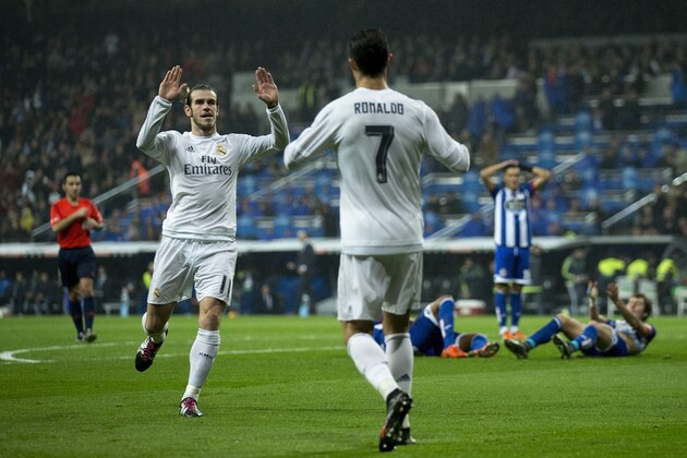 Real Madrid's Welsh forward Gareth Bale (L) celebrates a goal with Real Madrid's Portuguese forward Cristiano Ronaldo during the Spanish league football match Real Madrid CF vs RC Deportivo de la Coruna at the Santiago Bernabeu stadium in Madrid on January 9, 2016.   AFP PHOTO / GONZALO ARROYO / AFP / GONZALO ARROYO        (Photo credit should read GONZALO ARROYO/AFP/Getty Images)