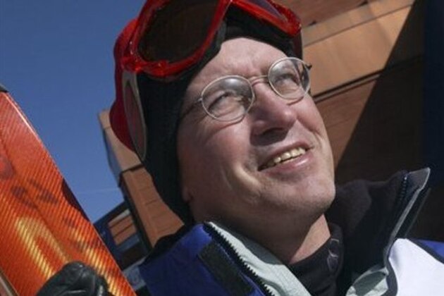 FILE - In this Dec. 11, 2002, file photo, Bill Johnson displays his gold medal for the downhill from the 1984 Winter Olympics while eyeing the ski slopes in Breckenridge, Colo.  A series of strokes over the past few years have all but immobilized Johnson, the skier who once lived life on the edge. His brash confidence, movie-star charisma and rebellious attitude made him a fan favorite at the 1984 Olympics, when he became the first American to capture the downhill crown(AP Photo/Peter M. Fredin, File)