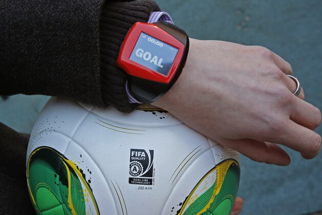 FILE - The Dec. 8, 2012 file photo shows a referee's watch with the goal as they demonstrate the goal-line technology of Hawk-Eye system at Toyota stadium in Toyota. The Bundesliga clubs have approved goal-line technology that will be introduced at the start of the next season. The technology chosen is the Hawk-Eye system, which is also used by England's Premier League.  (AP Photo/Shuji Kajiyama)