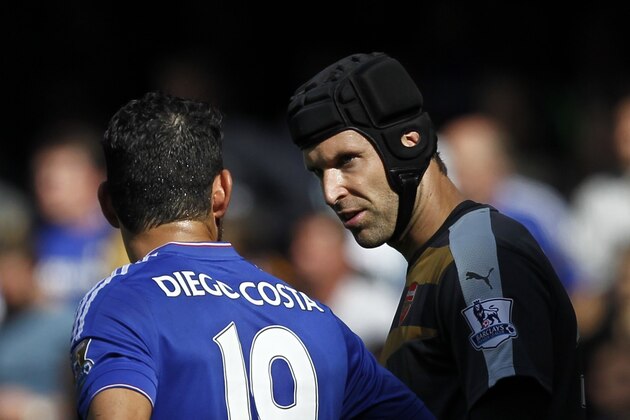 Chelsea's Brazilian-born Spanish striker Diego Costa (L) talks to Arsenal's Czech goalkeeper Petr Cech during the English Premier League football match between Chelsea and Arsenal at Stamford Bridge in London on September 19, 2015. AFP PHOTO / IAN KINGTON  RESTRICTED TO EDITORIAL USE. No use with unauthorized audio, video, data, fixture lists, club/league logos or 'live' services. Online in-match use limited to 75 images, no video emulation. No use in betting, games or single club/league/player publications.        (Photo credit should read IAN KINGTON/AFP/Getty Images)