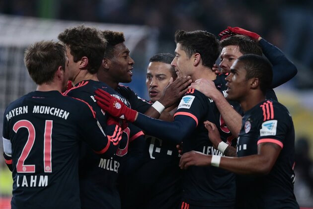 HAMBURG, GERMANY - JANUARY 22:  Robert Lewandowski (C) of Munich celebrates after scoring their first goal during the Bundesliga match between Hamburger SV and FC Bayern Muenchen at Volksparkstadion on January 22, 2016 in Hamburg, Germany.  (Photo by Oliver Hardt/Getty Images)