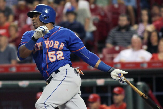 New York Mets Yoenis Cespedes hits an RBI single against the Cincinnati Reds in the seventh inning of a baseball game in Cincinnati, Thursday, Sept. 24, 2015. (AP Photo/Tom Uhlman)
