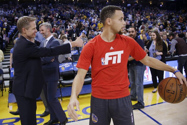 Golden State Warriors coach Steve Kerr, left, gives a thumbs-up next to guard Stephen Curry, right, before the team's NBA basketball game against the Indiana Pacers on Friday, Jan. 22, 2016, in Oakland, Calif. (AP Photo/Marcio Jose Sanchez)