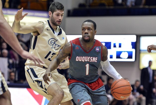 Jan 9, 2016; Washington, DC, USA; Duquesne Dukes guard Derrick Colter (1) drives as George Washington Colonials guard Patricio Garino (13) defends during the second half at Charles E. Smith Center. Mandatory Credit: Tommy Gilligan-USA TODAY Sports