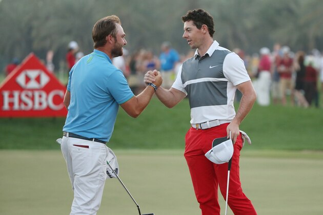 ABU DHABI, UNITED ARAB EMIRATES - JANUARY 23:  Andy Sullivan of England and Rory McIlroy of Northern Ireland shake hands on the 9th green after play was stopped due to bad light during the third round of the Abu Dhabi HSBC Golf Championship at the Abu Dhabi Golf Club on January 23, 2016 in Abu Dhabi, United Arab Emirates.  (Photo by Andrew Redington/Getty Images)