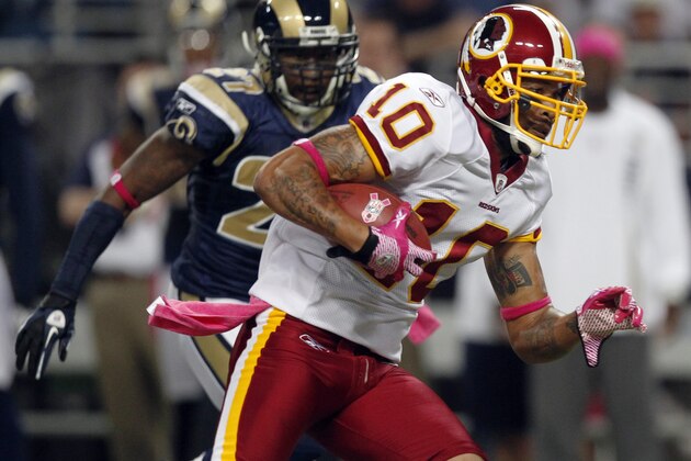 Washington Redskins wide receiver Jabar Gaffney (10) carries the ball after catching a pass for a 20-yard gain as St. Louis Rams cornerback Quintin Mikell, left, defends during the first quarter of the NFL football game Sunday, Oct. 2, 2011, in St. Louis. (AP Photo/Jeff Roberson)