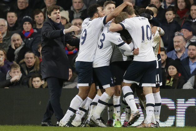 Tottenham Hotspur’s manager Maurico Pochettino, left congratulates Tottenham Hotspur’s Dele Alli who is mobbed after scoring his sides second gaol during the English Premier League soccer match between Crystal Palace and Tottenham Hotspur at Selhurst Park in London, Saturday Jan. 23, 2016. (AP Photo/Tim Ireland)