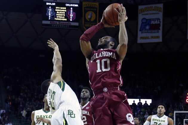 Oklahoma guard Jordan Woodard (10) scores over Baylor guard Al Freeman (25) in the first half of an NCAA college basketball game, Saturday, Jan. 23, 2016, in Waco, Texas. (AP Photo/Rod Aydelotte)