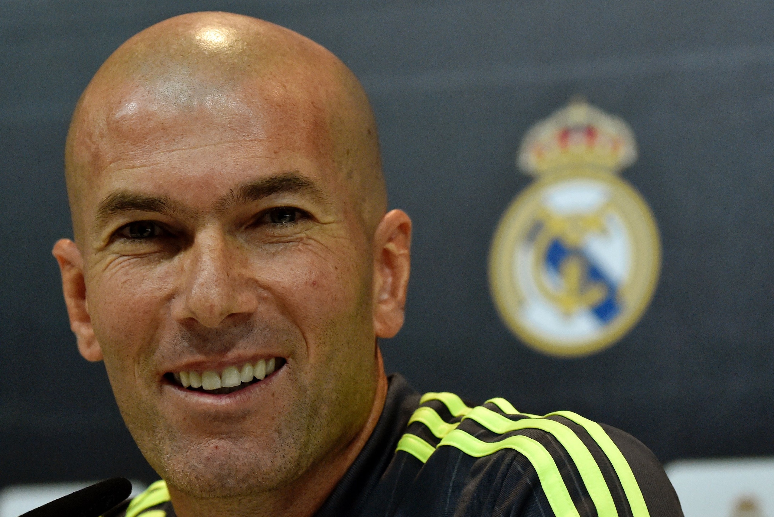Real Madrid's new French coach Zinedine Zidane smiles during a press conference at the Valdebebas training ground in Madrid on January 8, 2016.   AFP PHOTO / GERARD JULIEN / AFP / GERARD JULIEN        (Photo credit should read GERARD JULIEN/AFP/Getty Images)