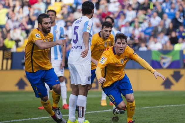 FC Barcelona's Lionel Messi, right, reacts after scoring against Malaga during a Spanish La Liga soccer match between Malaga and FC Barcelona at La Rosaleda stadium in Malaga, Spain, Saturday, Jan. 23, 2016. (AP Photo/Daniel Tejedor)