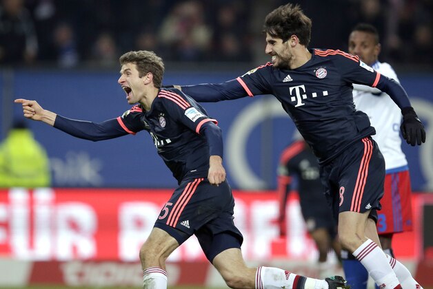 Bayern's Thomas Mueller, left, and Bayern's Javi Martinez, right, celebrate their side's 2nd goal scored by Robert Lewandowski during the German Bundesliga soccer match between Hamburger SV and FC Bayern Munich in Hamburg, Germany, Friday, Jan. 22, 2016. (AP Photo/Michael Sohn)