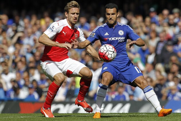 Chelsea's Spanish midfielder Pedro (R) vies with Arsenal's Spanish defender Nacho Monreal (L) during the English Premier League football match between Chelsea and Arsenal at Stamford Bridge in London on September 19, 2015. Chelsea won the game 2-0. AFP PHOTO / IAN KINGTON  RESTRICTED TO EDITORIAL USE. No use with unauthorized audio, video, data, fixture lists, club/league logos or 'live' services. Online in-match use limited to 75 images, no video emulation. No use in betting, games or single club/league/player publications.        (Photo credit should read IAN KINGTON/AFP/Getty Images)