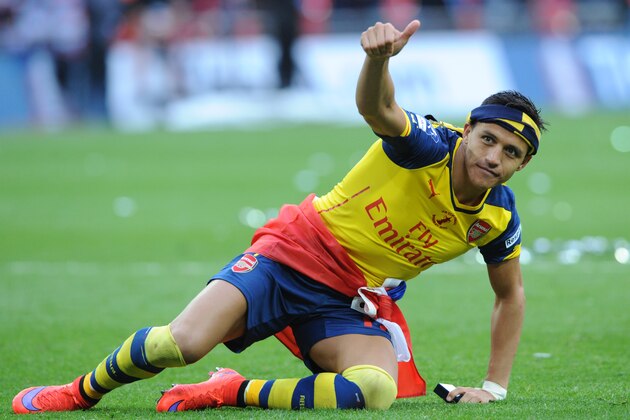 Arsenal's Alexis Sanchez salutes the fans after his team won the English FA Cup final soccer match between Aston Villa and Arsenal at Wembley stadium in London, Saturday, May 30, 2015. Arsenal won the match 4-0. (AP Photo/Rui Vieira) Arsenal's Alexis Sanchez salutes the fans after his team won the English FA Cup final soccer match between Aston Villa and Arsenal at Wembley stadium in London, Saturday, May 30, 2015. Arsenal won the match 4-0. (AP Photo/Rui Vieira)
