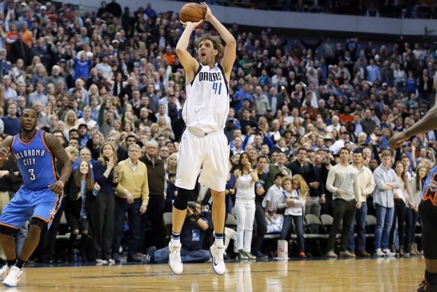 Oklahoma City Thunder's Dion Waiters (3) looks on as Dallas Mavericks forward Dirk Nowitzki (41) of Germany attempts a 3-point basket in the second half of an NBA basketball game, Friday, Jan. 22, 2016, in Dallas. The Thunder won 109-106. (AP Photo/Tony Gutierrez)
