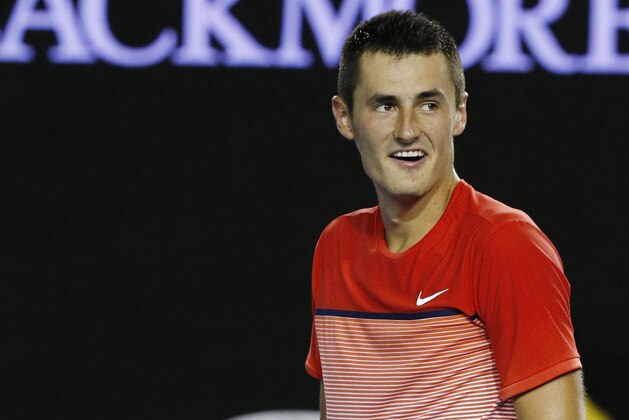 Bernard Tomic of Australia celebrates after defeating compatriot John Millman during their third round match at the Australian Open tennis championships in Melbourne, Australia, Sunday, Jan. 24, 2016.(AP Photo/Vincent Thian)