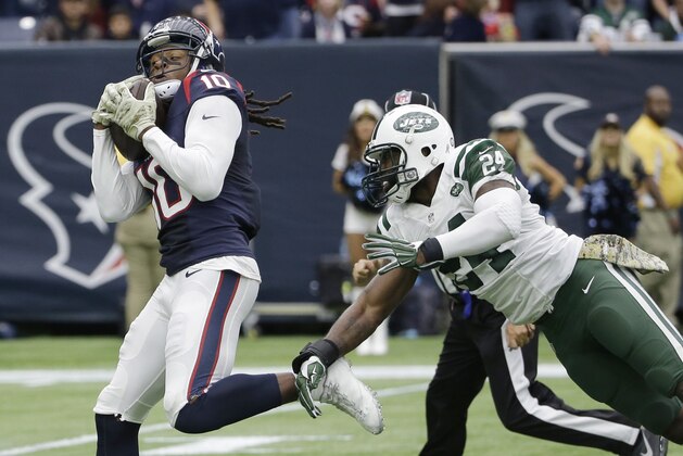 Houston Texans wide receiver DeAndre Hopkins (10) pulls in a pass for a touchdown as he is defended by New York Jets cornerback Darrelle Revis (24) during the first half of an NFL football game, Sunday, Nov. 22, 2015, in Houston. (AP Photo/David J. Phillip)